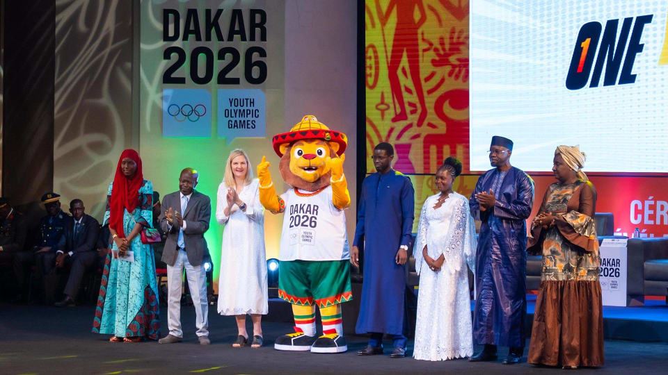 Ayo, the lion mascot of Dakar 2026, on stage at the official unveiling